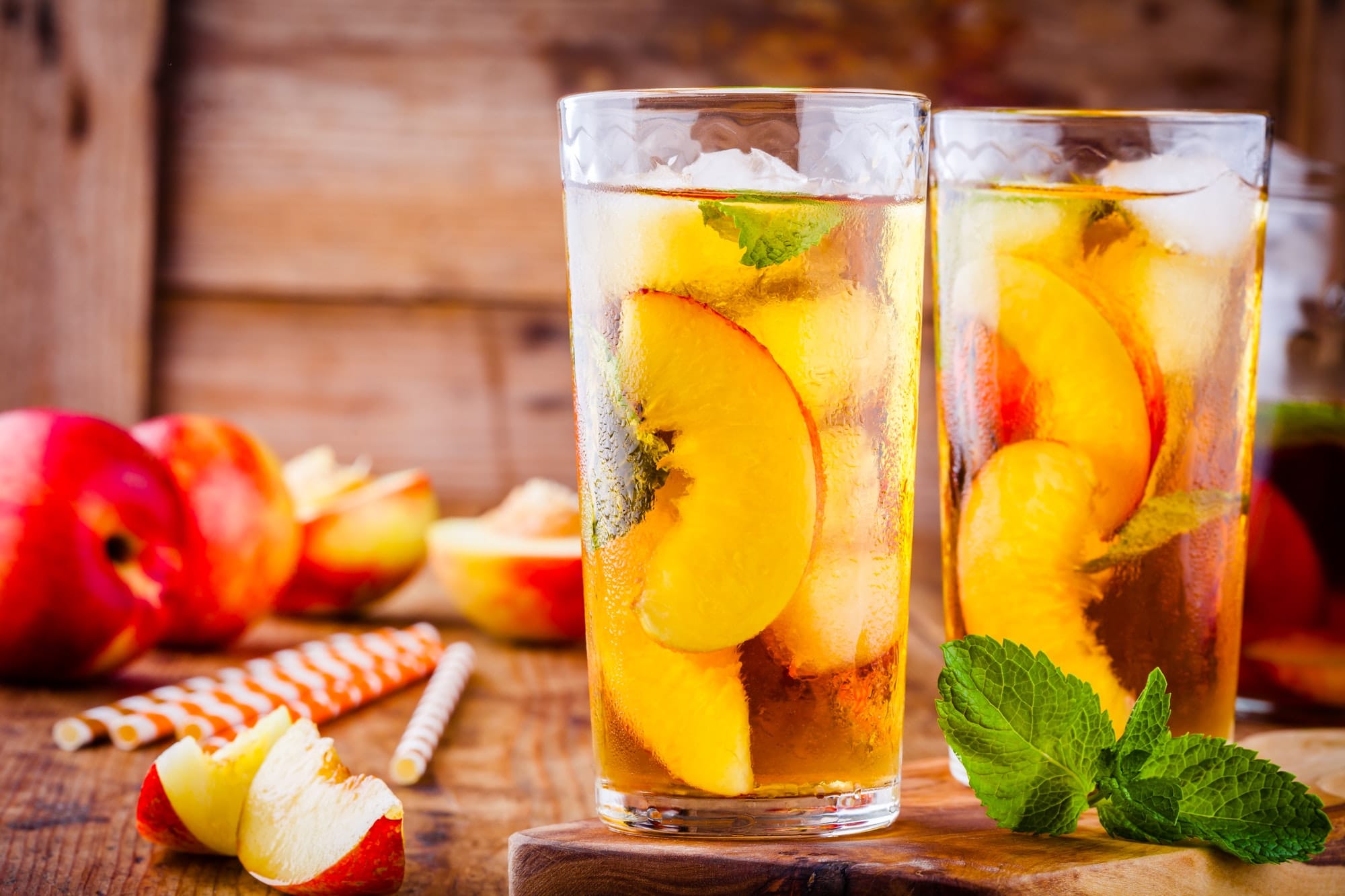 Peach ice tea in a glass with mint